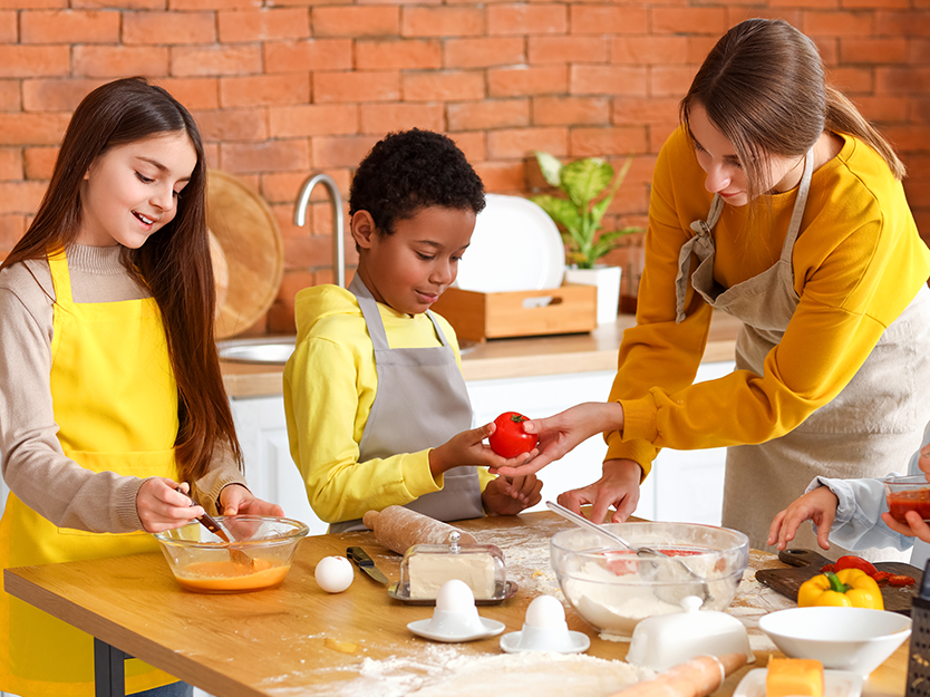 2 kids cooking with an adult