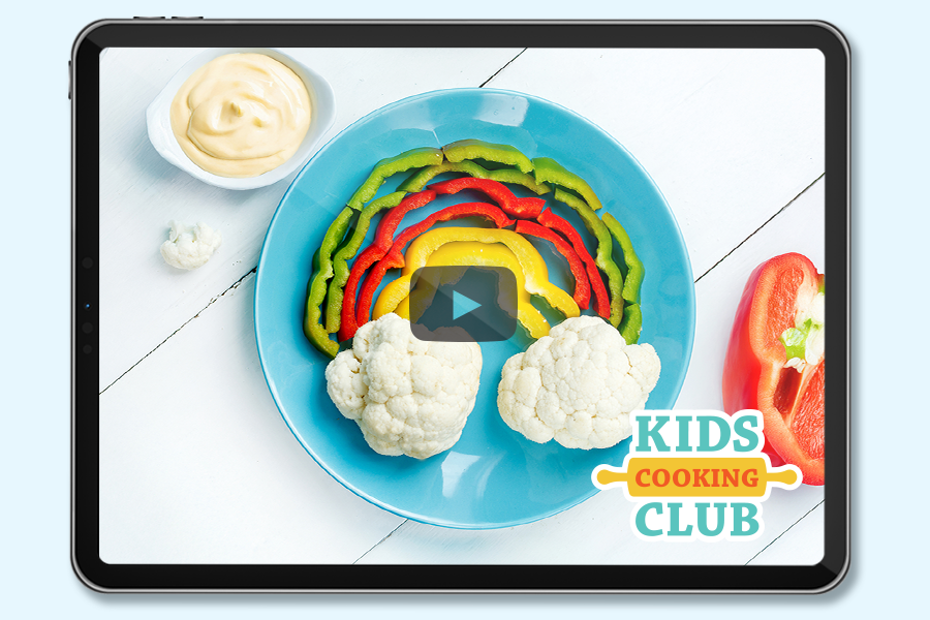 rainbow made with colorful peppers and cauliflower as clouds with a heart-shaped bowl filled with dip- logo Kids Cooking Club